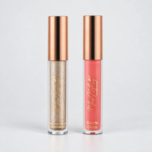 Two liquid lipstick tubes from the brand 'Moe Moe Beauty' standing side-by-side on a light gray background. The left tube contains a sparkling champagne-gold glitter liquid, and the right tube contains a coral pink liquid, both with metallic rose gold caps.