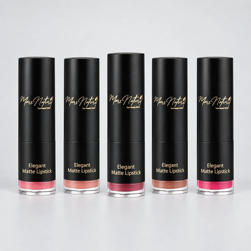 Five black tubes of Max Naturally Matte Lipstick lined up on a light gray reflective surface, showing different lipstick shades from pink to nude brown.