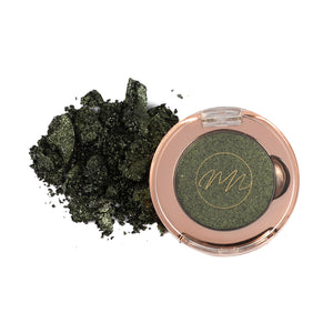 A pan of olive green eyeshadow with a shimmery finish, alongside a scattered pile of the eyeshadow powder.