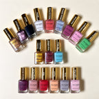 A collection of Millie Moon nail polishes arranged in rows on a light beige background, showcasing various colors and finishes including glitter, metallic, and solid shades.