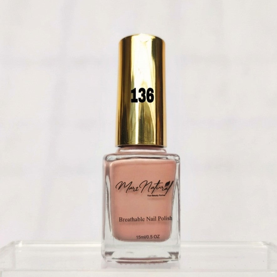 A bottle of Marc Vuitton Breathable Nail Polish in shade 136, featuring a metallic gold cap and a light peach-pink nail polish inside a clear glass bottle, displayed on a clear acrylic stand against a white background.