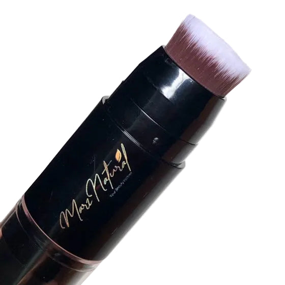Makeup brush with black handle and pink bristle tip on a white background