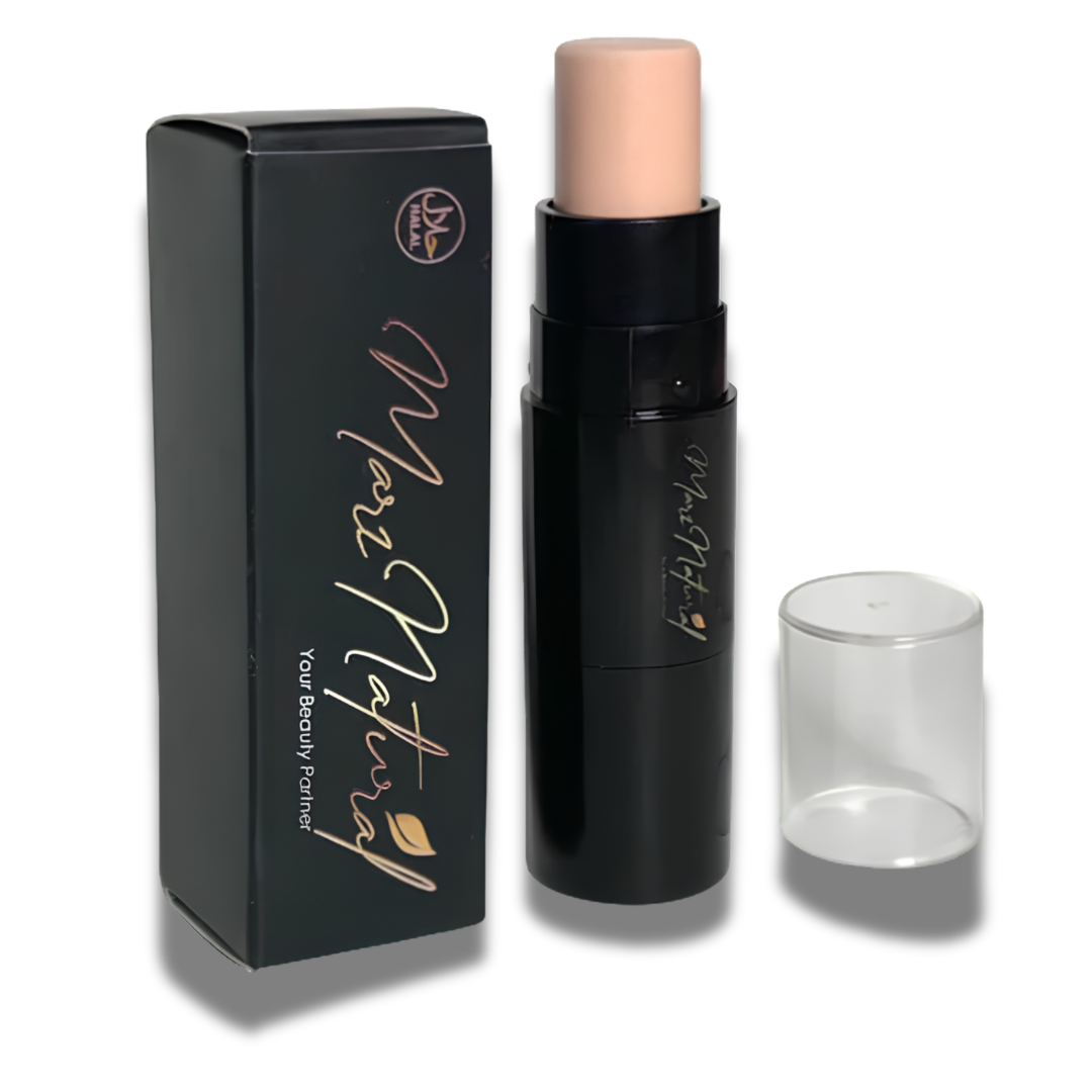 A makeup stick product shown with its black retail box, the open stick in a black tube, and a clear cylindrical cap on a white background. The stick tip is a light peach-beige shade, and the packaging features gold script branding.