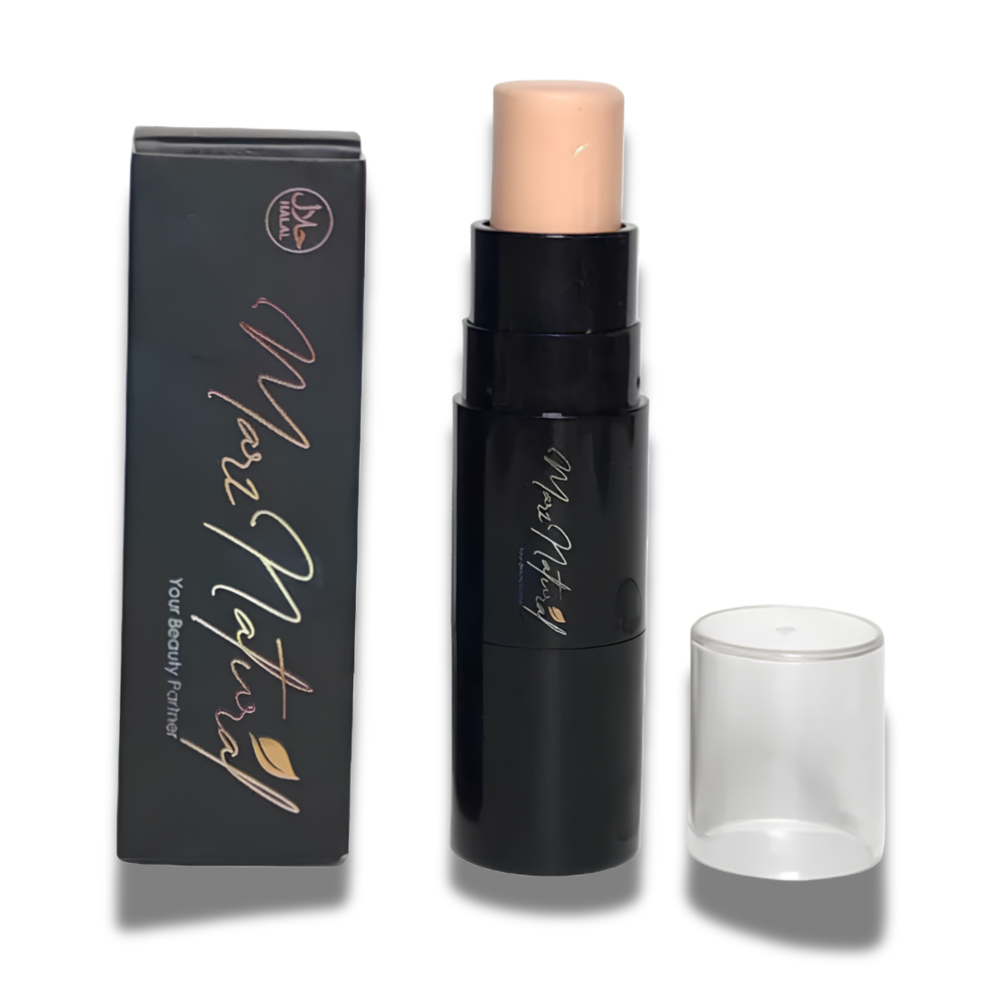 A black cosmetic stick with a light beige cream product exposed, shown next to its black branded box and a clear cap on a white background.